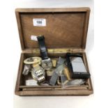 A trinket box containing Seiko and other watches, lighters including Dunhill and Zippo,