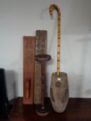 A rustic wooden pot together with walking stick, smoker's stand,