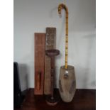 A rustic wooden pot together with walking stick, smoker's stand,