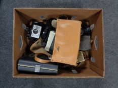 A box of vintage cameras and camera bags