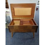 A mid century teak Arnold sewing table