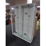 A pair of contemporary glass door display cabinets