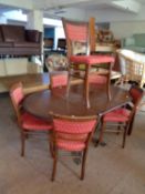 An inlaid mahogany flap sided pedestal table and six stained beech chairs