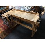 A twentieth century wood working bench fitted with vices CONDITION REPORT: