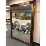 A 6' by 4' gold floor standing mirror