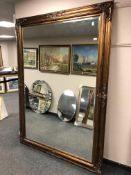 A 6' by 4' gold floor standing mirror