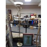 A contemporary floor lamp with four assorted framed pictures