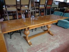 An early twentieth century oak pull out table on bulbous legs