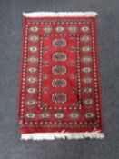 A Tekke design rug on red ground,