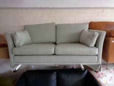 A twentieth century two seater settee in green fabric