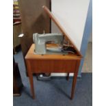 A Singer electric sewing machine in teak table