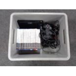 A plastic crate of PS2 slim controllers and leads,