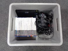 A plastic crate of PS2 slim controllers and leads,