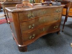 An antique mahogany serpentine fronted three drawer chest