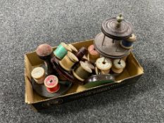 A box containing four wooden thimble and thread stands,