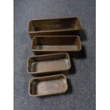 A set of four graduated copper trays/fish kettles