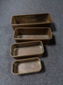 A set of four graduated copper trays/fish kettles