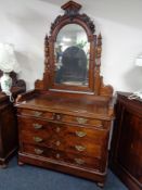 A late nineteenth century continental five drawer dressing chest with mirror and brass drop handles