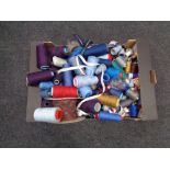 A large plastic tub of zips together with a box of spools of thread