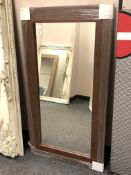 A brown contemporary flat framed mirror