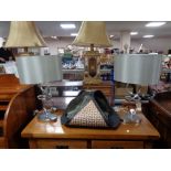 A pair of contemporary chrome table lamps together with a leather log basket and carved cornice