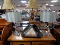 A pair of contemporary chrome table lamps together with a leather log basket and carved cornice