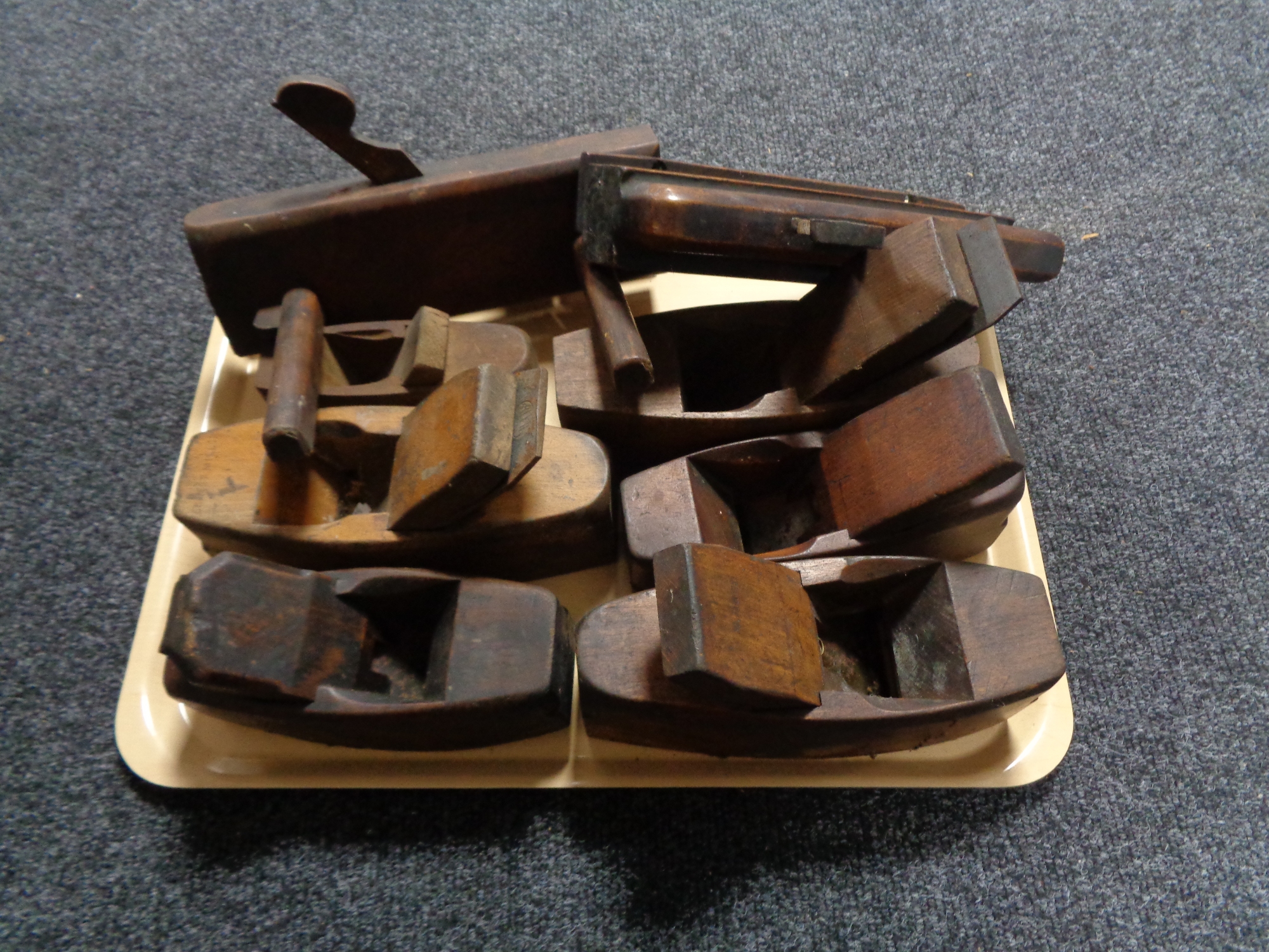 A tray of vintage wood working planes