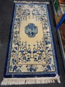 A blue fringed Chinese rug,