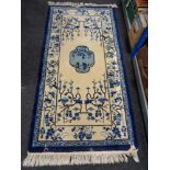 A blue fringed Chinese rug,