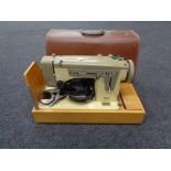 A cased Alfa electric sewing machine CONDITION REPORT: This item has not been