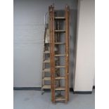A set of folding wooden ladders together with a wooden triple section extension ladder