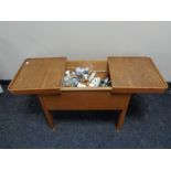 A mid century sewing box with contents