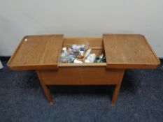 A mid century sewing box with contents