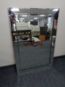 A contemporary all glass bevelled edge mirror