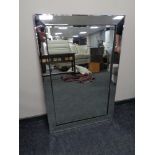 A contemporary all glass bevelled edge mirror