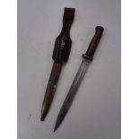 A WW II German bayonet in scabbard with leather holster