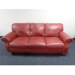 A Barker & Stonehouse three seater scroll arm settee in red leather