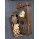 An early twentieth century oak wall clock case with later smiths movement,