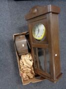 An early twentieth century oak wall clock case with later smiths movement,