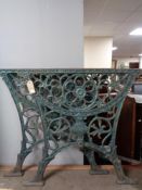 A pair of cast iron table ends 68.5 cm width x 65 cm height.