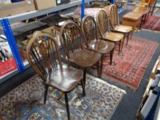 Five wheel backed dining chairs
