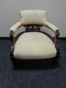 A Victorian mahogany armchair in cream floral fabric