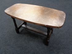 A copper topped coffee table together with two plant stands