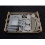 A box of contemporary dinner ware and mugs