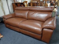 A brown leather reclining settee