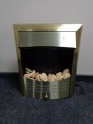 A brass framed electric fire