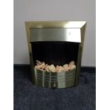 A brass framed electric fire