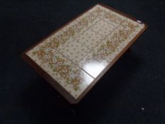A mid century teak tiled coffee table