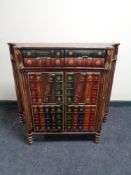 A double door bookcase fitted with two drawers with faux book front