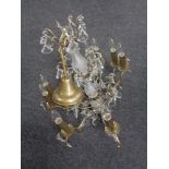 A decorative metal and glass eight branch chandelier with crystal drops